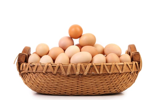 Brown eggs in the basket on a white