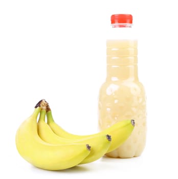 Banana and bottle of juice. On a white
