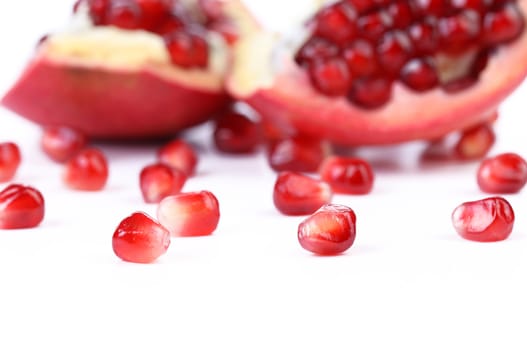 Ripe pomegranate piece isolated on white background