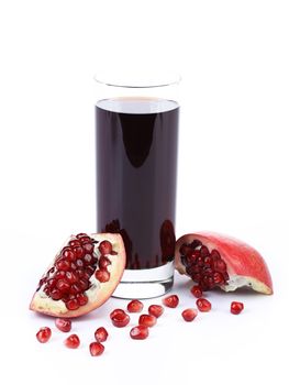 Glass of pomegranate juice with sliced fruits isolated on white