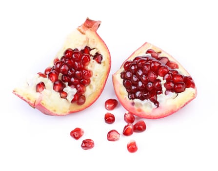 Two ripe pomegranate pieces isolated on white background
