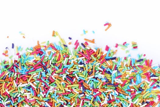 Colorful sugar sprinkles on a white background