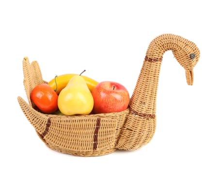 Artificial fruits in wicker basket isolated on white background