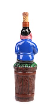 Souvenir bottle of wine. Man pressing grapes. Isolated on a white background.