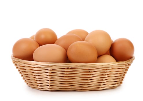 Brown eggs in the basket on white