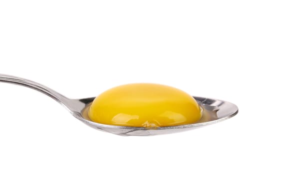 Egg yolk on a silver spoon isolated on a white background