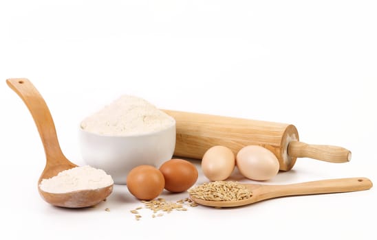 Composition of flour and eggs. Isolated on a white background.