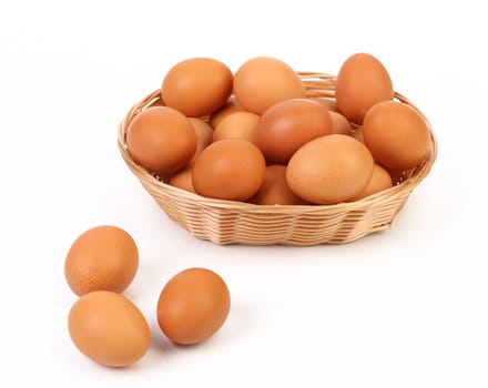Brown eggs in the basket on a white background
