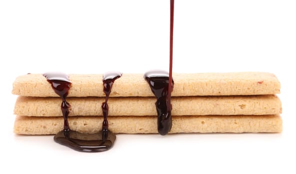 Stream chocolate on stics of biscuit. Isolated