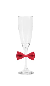 Tall wineglass and red bow tie. White background.