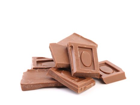 Pieces of milk chocolate on a white background