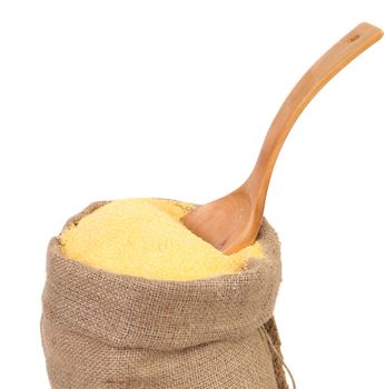 bag of ground corn and a wooden spoon on a white background. keeping paths