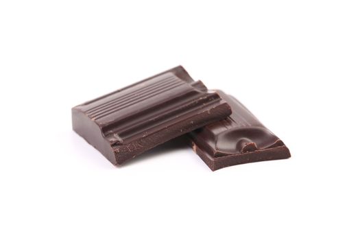 Tasty morsel of dark chocolate. Isolated on a white background.