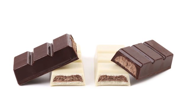 Black and white chocolate bars with filling. White background.