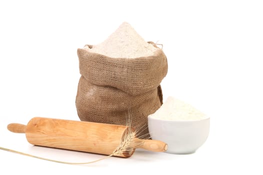 White flour and rolling pin. Isolated on a white background.
