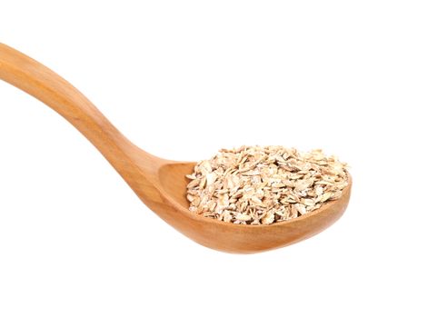 Oatmeal flakes into wooden spoon. Isolated on a white background.