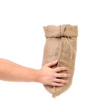 Hand holds bag of money. Isolated on a white background.