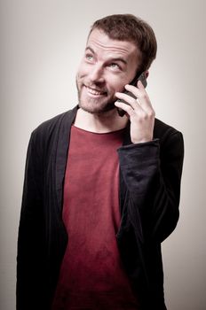 stylish hipster man on the phone on gray background