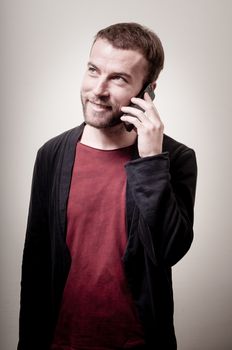stylish hipster man on the phone on gray background