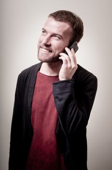 stylish hipster man on the phone on gray background