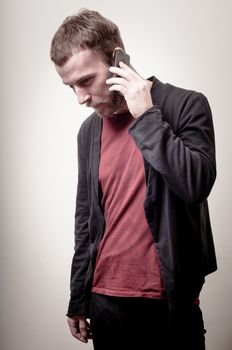 stylish hipster man on the phone on gray background