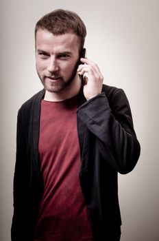 stylish hipster man on the phone on gray background