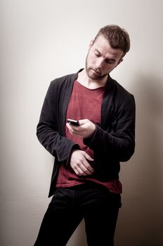 stylish hipster man on the phone on gray background