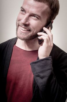 stylish hipster man on the phone on gray background