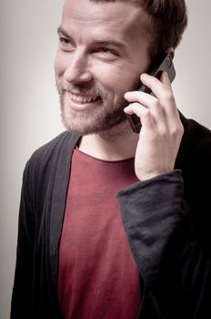 stylish hipster man on the phone on gray background