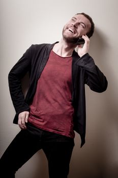 stylish hipster man on the phone on gray background