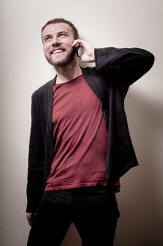 stylish hipster man on the phone on gray background