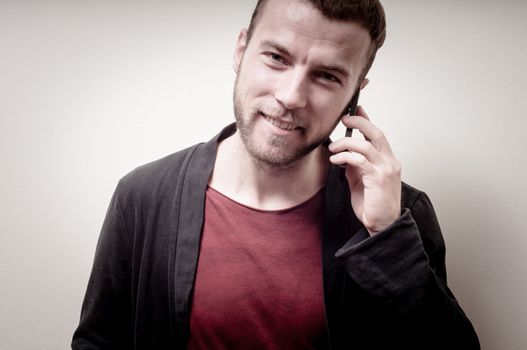 stylish hipster man on the phone on gray background