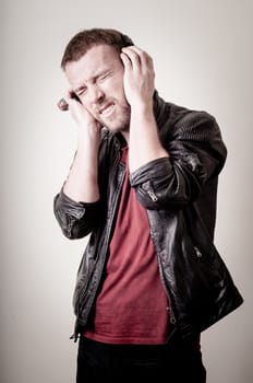stylish hipster listening to music on gray background