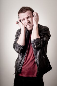 stylish hipster listening to music on gray background