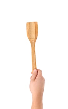 Hand holds woodfen spatula. Isolated on a white background.