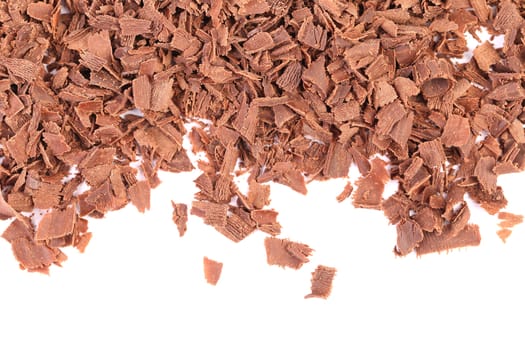 Grated chocolate. There is white space. White background.