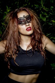 Sensual venetian mask. Beautiful Teenage Model Dressed in Fashionable Short Dress. Beauty Romantic Girl Outdoor. Toned in warm colors. Fashion Look