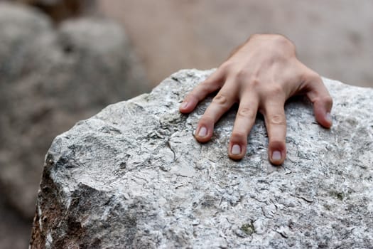 Hand holding a rock at the top