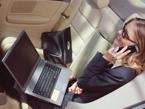 business travel, busy businesswoman with laptop in car