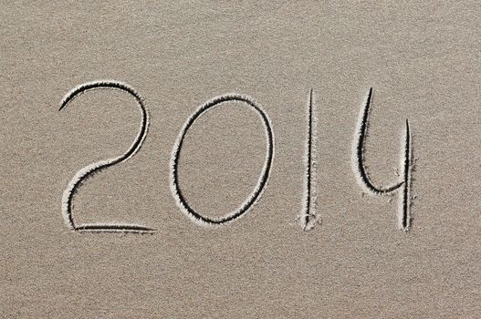 New Year background. 2014 written in sand