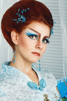 Portrait of attractive girl with make-up Geisha, shot close-up