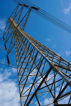 High voltage power lines on blue sky background