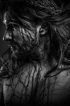 Jesus Christ calvary, man bleeding, representation of passion with crown of thorns