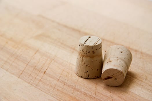 Two wine corks on wooden scratched background