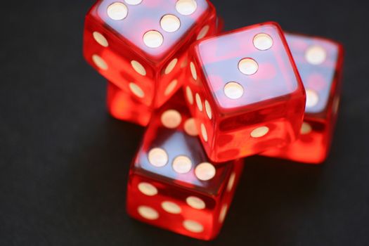 Red dice on black background