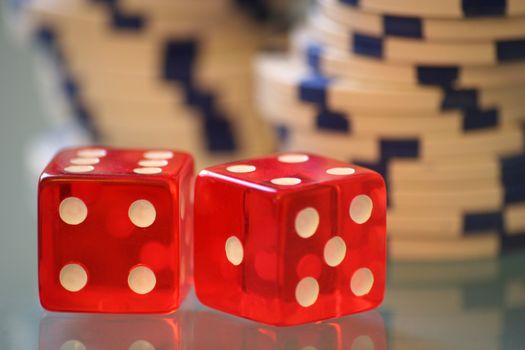 Red dice with white casino chips