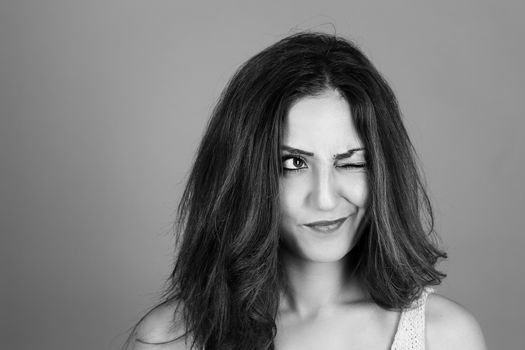 black and white portrait of a beautiful brunette woman making faces 