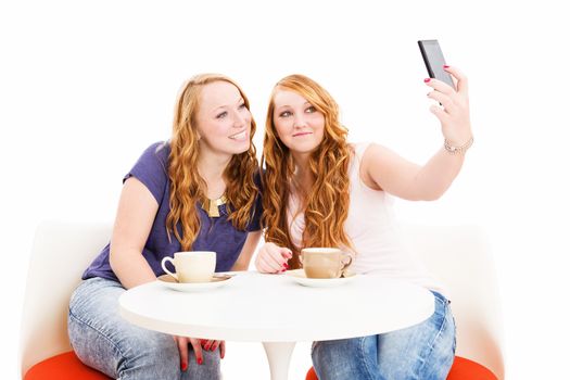 female friends at a coffee table making photos from themselves on white background