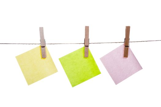 Blank paper cards hanging on clothespins