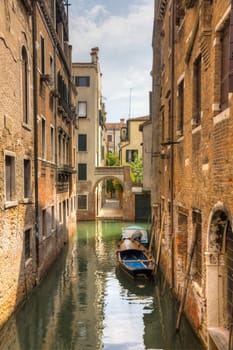 Canal in venezia with a boat in the middle